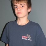 Zack Stout wearing a Rise Against Rattlesnake Roundups T-Shirt